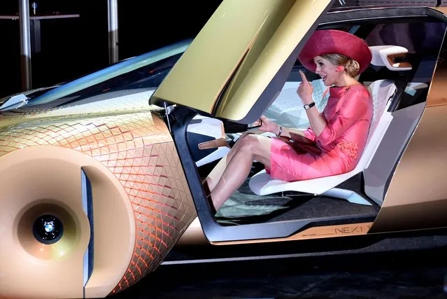 Queen Maxima sits in the in the concept car “Vision Next 100” at “BMW World” in Munich, Germany, Wednesday, April 13, 2016. The Dutch Royal couple is on a two day visit in the southern German state of Bavaria. (Photo by  Angelika Warmuth/dpa via AP Photo)
