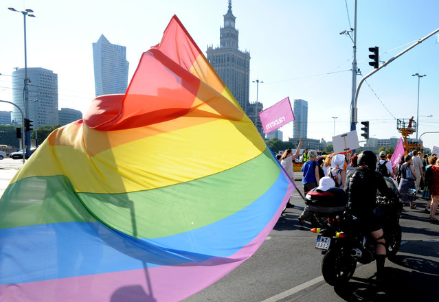A biker with a multicolor flag attends the annual gay pride parade in Warsaw, Poland, Saturday, June 13, 2015. Gay rights activists hold their 15th yearly "Equality Parade" as Poland slowly grows more accepting of gays and lesbians, but where gay marriage, and even legal partnerships, still appear to be a far-off dream. This year's parade comes amid a right-wing political shift, a possible setback for the LGBT community. (AP Photo/Alik Keplicz)