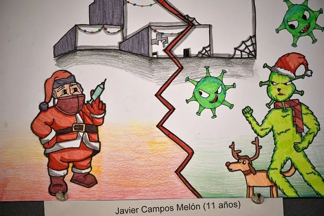The fighting between vaccines and COVID-19 seen in a drawing of a young boy displayed in a wall during the last Christmas days at San Pedro Hospital in Logrono, northern Spain, Tuesday, January 18. 2022. Spanish authorities try to control the high incidence curve of COVID-19 and collapse of the hospitals. (Photo by Alvaro Barrientos/AP Photo)