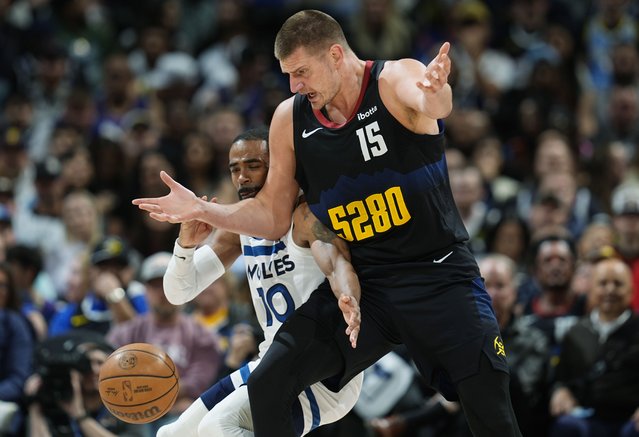 Denver Nuggets center Nikola Jokic, front, reacts as he loses the ball to Minnesota Timberwolves guard Mike Conley in the second half of Game 2 of an NBA basketball second-round playoff series, Monday, May 6, 2024, in Denver. (Photo by David Zalubowski/AP Photo)