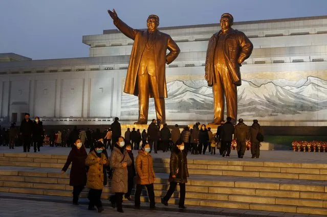 Citizens visit the bronze statues of their late leaders Kim Il Sung, left, and Kim Jong Il on Mansu Hill in Pyongyang, North Korea Thursday, December 16, 2021, on the occasion of 10th anniversary of demise of Kim Jong Il. (Photo by Jon Chol Jin/AP Photo)