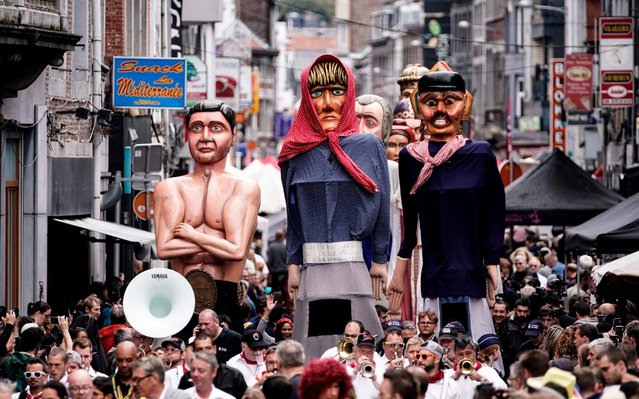 Giant puppets are carried through the streets during a folk parade on August 15, 2019 in Outremeuse, Liege, Belgium, on August 15, 2019 during Assumption Day celebrations. (Photo by Kenzo Tribouillard/AFP Photo)