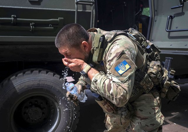 A Ukrainian serviceman washes his face after evacuating a wounded counterpart from the front line, near the town of Vovchansk in Kharkiv region, Ukraine, on May 12, 2024. (Photo by Vyacheslav Madiyevskyy/Reuters)