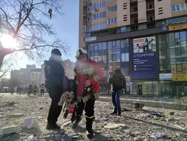 A screengrab from a video shows emergency service workers carrying a person at the site of a damaged multi-storey residential building in an aftermath of shelling, after Russia launched a massive military operation against Ukraine, in south-west of Kyiv, Ukraine on February 26, 2022. (Photo by State Emergency Services of Ukraine/Reuters TV)