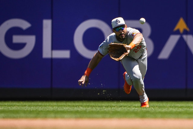 Baltimore Orioles right fielder Anthony Santander makes a diving catch on a fly ball hit by Seattle Mariners' Cal Raleigh during the first inning of a baseball game Thursday, July 4, 2024, in Seattle. (Photo by Lindsey Wasson/AP Photo)