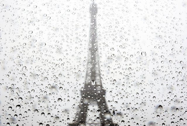 Rain drops reflect the Eiffel Tower at the beach volleyball venue Champ de Mars ahead of the Paris 2024 Olympic Games on July 23, 2024 in Paris, France. (Photo by Steph Chambers/Getty Images)