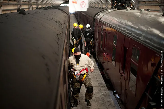 Police take part in a role play exercise as they clear a protest on top of a train during training in Oxenhope, England