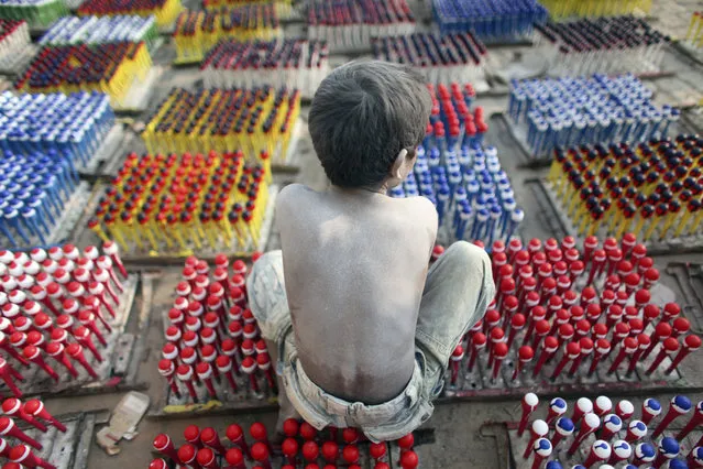 Hridoy, 7, works at a balloon factory on the outskirts of Dhaka November 26, 2009. About 20 children are employed at the factory and most of them work for 12 hours a day. The weekly wage is 150 taka ($2.14) for the children. (Photo by Andrew Biraj/Reuters)