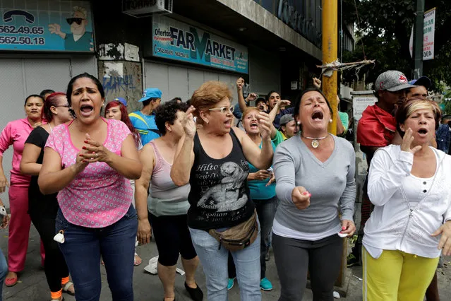 People shout at Venezuelan National Guards (not pictured) during riots for food in Caracas, Venezuela, June 2, 2016. (Photo by Marco Bello/Reuters)