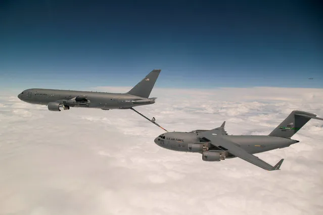 Boeing's KC-46 aerial refueling tanker conducts receiver compatibility tests with a U.S. Air Force C-17 Globemaster III from Joint Base Lewis-McChord, in Seattle, Washington, U.S., July 12, 2016. (Photo by Christopher Okula/Reuters/U.S. Air Force)