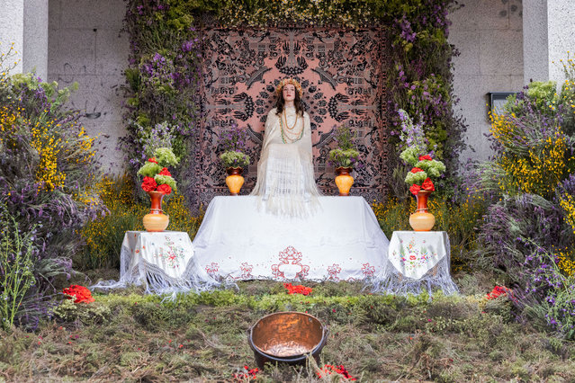 A La Maya girl sits on the altar during the celebration of La Maya festivity on May 02, 2023 in Colmenar Viejo, Spain. Las Mayas, typically girls in Colmenar Viejo, are chosen to sit at a freshly made flower altar to mark the new spring season. (Photo by Aldara Zarraoa/Getty Images)