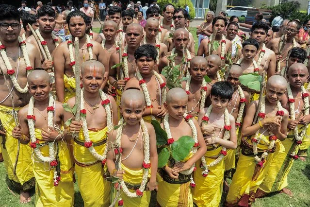 Young Hindu boys belonging to the Brahmin community take part in a mass “Upanayana” the sacred thread ceremony, performed by young Brahmin boys symbolising their initiation into formal Vedic education, in Bangalore on May 2, 2022. (Photo by Manjunath Kiran/AFP Photo)