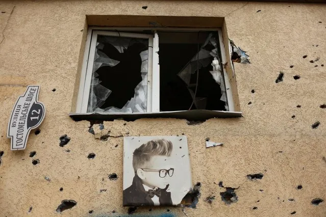 An advertising picture is seen at a hair salon damaged by Russian shelling, in a residential area, as the Russian invasion of Ukraine continues, in Irpin, Ukraine, May 14, 2022. (Photo by Ahmed Jadallah/Reuters)