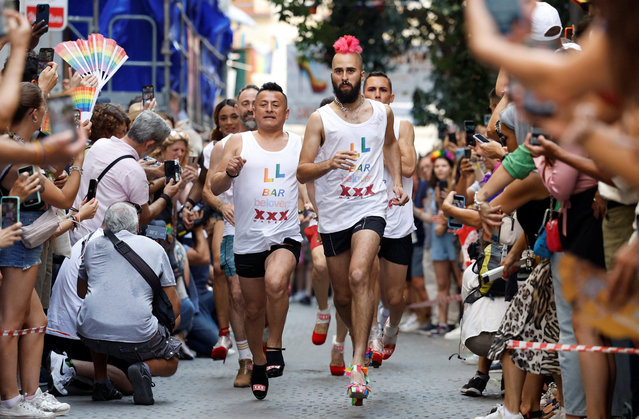 Contestants take part in the annual race on high heels during Pride celebrations in the quarter of Chueca in Madrid, Spain on June 29, 2023. (Photo by Juan Medina/Reuters)