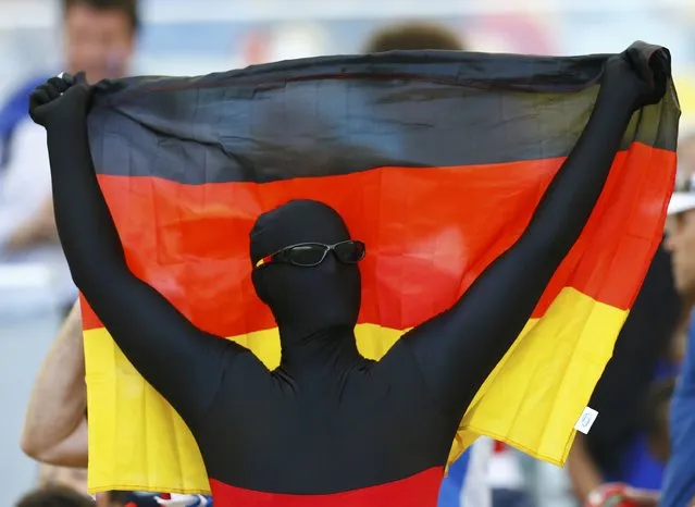 A fan of Germany holds their national flag as he waits for the 2014 World Cup quarter-finals soccer match against France at the Maracana stadium in Rio de Janeiro July 4, 2014. (Photo by Darren Staples/Reuters)