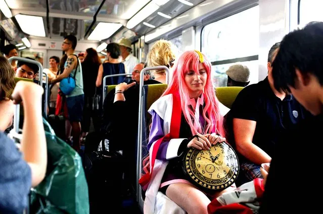 A woman dressed like a manga character sits on the train, on the way to the 16th edition of the Japan Expo exhibition, in Villepinte, north of Paris, Thursday, July 2, 2015. (Photo by Thibault Camus/AP Photo)