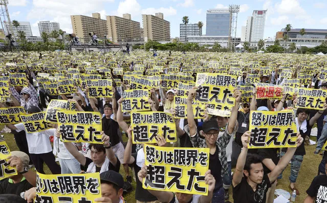 Protesters hold placards that read: “Our anger has reached its limit” during a protest rally against the presence of U.S. military bases on the southwestern island of Okinawa in Naha, Okinawa, Sunday, June 19, 2016 as many of them wearing black to mourn the rape and killing of a local woman in which a former U.S. Marine is a suspect. The rally called for a review of the U.S.-Japanese security agreement, which burdens Okinawa with hosting the bulk of American troops in Japan. (Photo by Ryosuke Uematsu/Kyodo News via AP Photo)