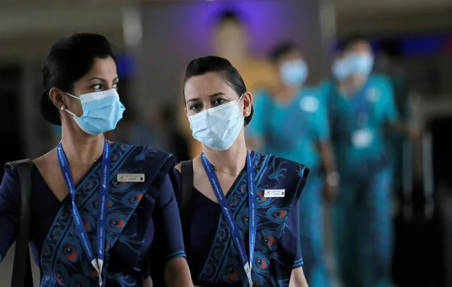 Sri Lankan Airlines staff wear masks at Bandaranaike International Airport after Sri Lanka confirmed the first case of coronavirus in the country, in Katunayake, Sri Lanka on January 30, 2020. (Photo by Dinuka Liyanawatte/Reuters)