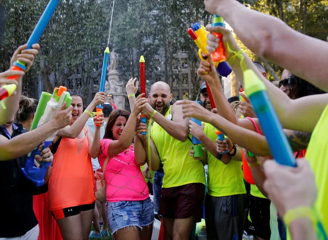 Revellers spray water during a gay pride parade in downtown Madrid, Spain, July 2, 2016. (Photo by Andrea Comas/Reuters)