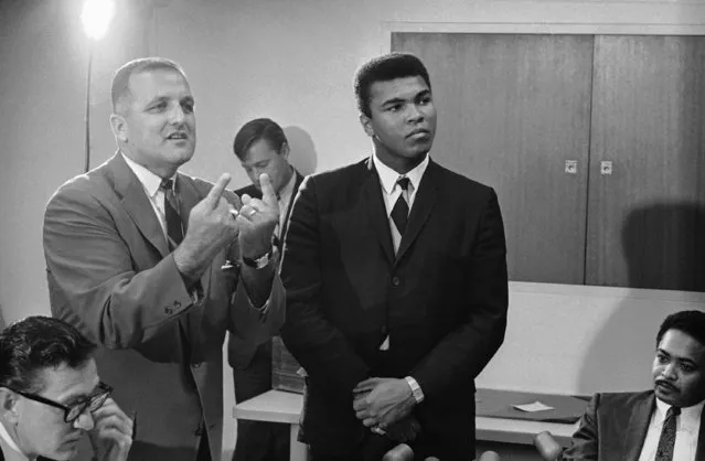 Muhammad Ali listens as his attorney, John Crvarich, pleads with the California Athletic Commission in Sacramento, Calif. in an attempt to get his boxing license renewed, July 12, 1967. His application was denied by the commission. Ali wanted to defend his championship in Oakland, Calif. and give all proceeds except $100 to feed the poor in the South. (Photo by Walter Zeboski/AP Photo)