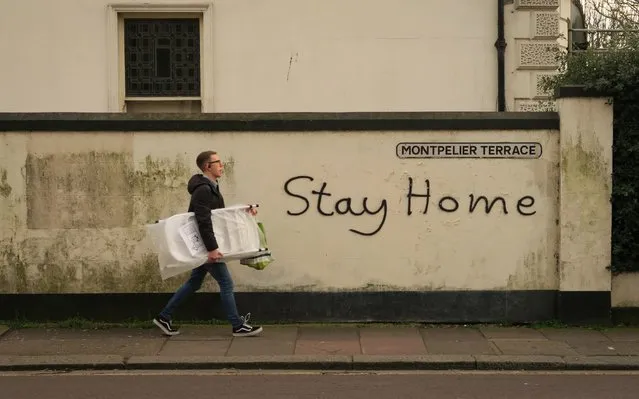 “Stay home” is graffitied on a wall in Brighton on March 17, 2020 in Brighton, England. Boris Johnson held the first of his public daily briefing on the Coronavirus outbreak yesterday and told the public to avoid theatres, going to the pub and work from home where possible. The number of people infected with COVID-19 in the UK reached 1500 today with 36 deaths. (Photo by Mike Hewitt/Getty Images)