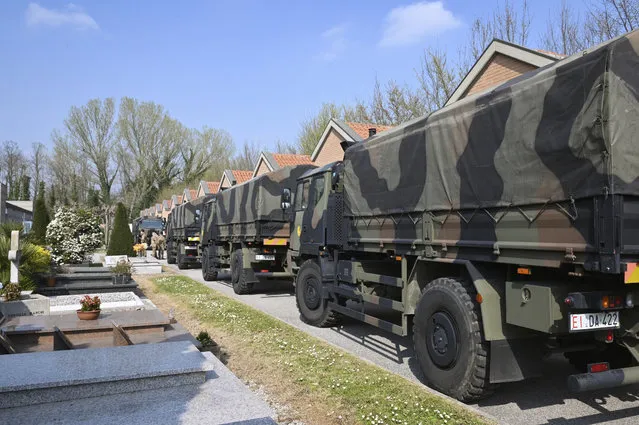 A convoy of Italian Army trucks arrives from Bergamo carrying bodies of coronavirus victims to the cemetery of Ferrara, Italy, where they will be cremated, Saturday, March 21, 2020. The transfer was made necessary since Bergamo mortuary reached maximum capacity. (Photo by Massimo Paolone/LaPresse via AP Photo)