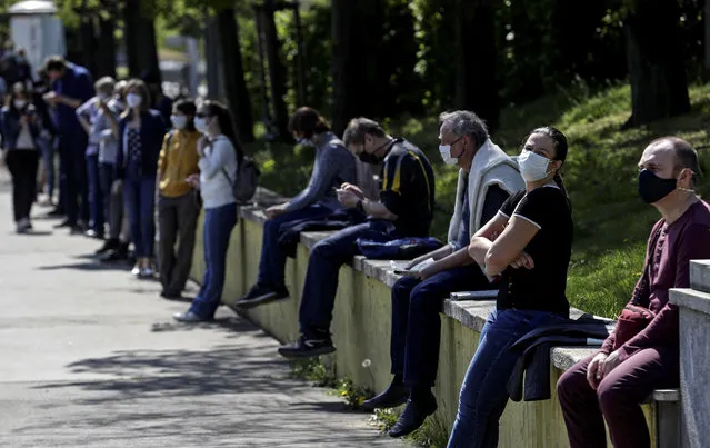 People keep social distance while waiting in line to be tested for the coronavirus disease (COVID-19) as a part of a study about undetected infections with the coronavirus in the population in Prague, Czech Republic, April 23, 2020. (Photo by David W. Cerny/Reuters)