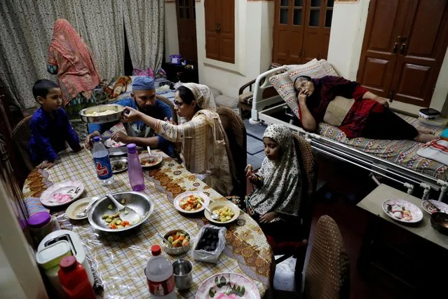 Gohar Sultan (70) looks on as her family eats an Iftar meal at their house, on the first day of the Muslim fasting month of Ramadan following the outbreak of the coronavirus disease (COVID-19) in the old quarters of Delhi, India, April 25, 2020. (Photo by Anushree Fadnavis/Reuters)