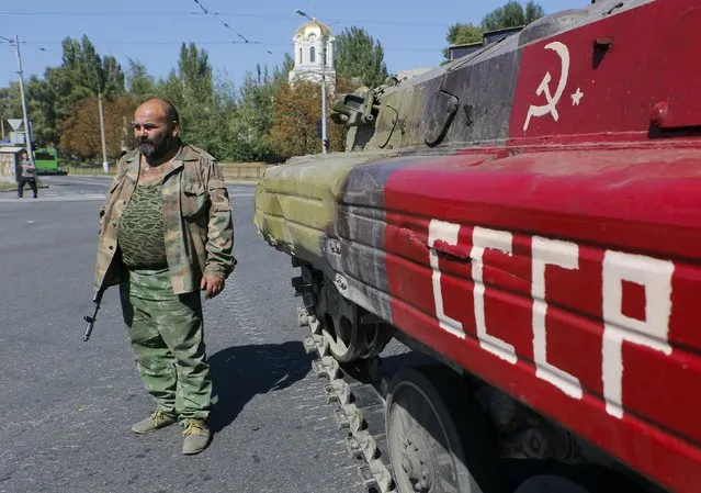 An armed pro-Russian separatist stands next to an APC in the city of Donetsk, eastern Ukraine, September 2, 2014. (Photo by Maxim Shemetov/Reuters)