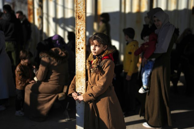 Syrians wait to cross into Syria from Turkey at the Oncupinar border gate, near the town of Kilis, southern Turkey, Monday, December 9, 2024. (Photo by Khalil Hamra/AP Photo)