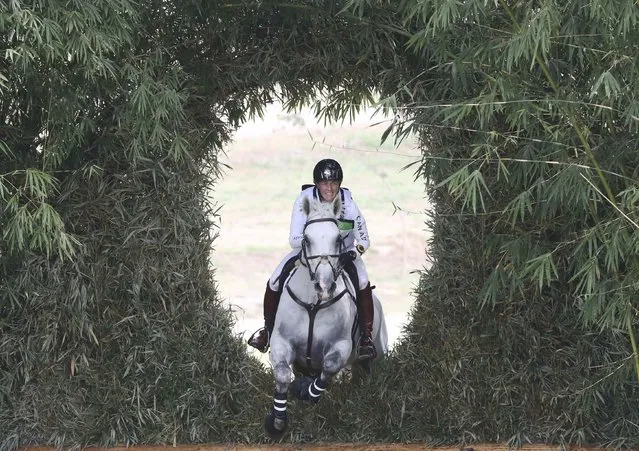2016 Rio Olympics, Equestrian, Preliminary, Eventing Individual Cross Country, Deodoro Olympic Equestrian Centre, Rio de Janeiro, Brazil on August 8, 2016. Colleen Loach (CAN) of Canada riding Qorry Blue D'argouges jumps through the bamboo keyhole. (Photo by Adrees Latif/Reuters)