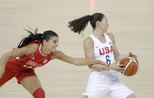 Serbia guard Ana Dabovic reaches in and fouls United States guard Sue Bird (6) during the first half of a women's basketball game at the Youth Center at the 2016 Summer Olympics in Rio de Janeiro, Brazil, Wednesday, August 10, 2016. (Photo by Carlos Osorio/AP Photo)