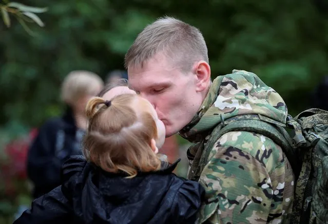A Russian reservist bids farewell to relatives before his departure for a base in the course of partial mobilization of troops, aimed to support the country's military campaign in Ukraine, in the town of Volzhsky in the Volgograd region, Russia on September 28, 2022. (Photo by Reuters/Stringer)