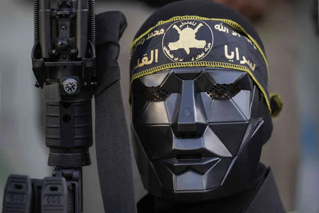 An armed Palestinian member of the Islamic Jihad militant group marches during a rally marking the 35th anniversary of the movement's foundation, in the Jenin refugee camp, West Bank Thursday, October 6, 2022. The Iranian-backed group, branded a terrorist organization by Israel and its Western allies, opposes Israel's existence and its members in Jenin have frequently clashed with Israeli troops. (Photo by Majdi Mohammed/AP Photo)