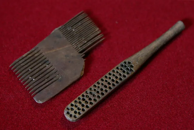 A Tudor comb and a Victorian toothbrush, which were excavated from the River Thames by mudlark Jason Sandy, are displayed at his home in London, Britain June 01, 2016. (Photo by Neil Hall/Reuters)