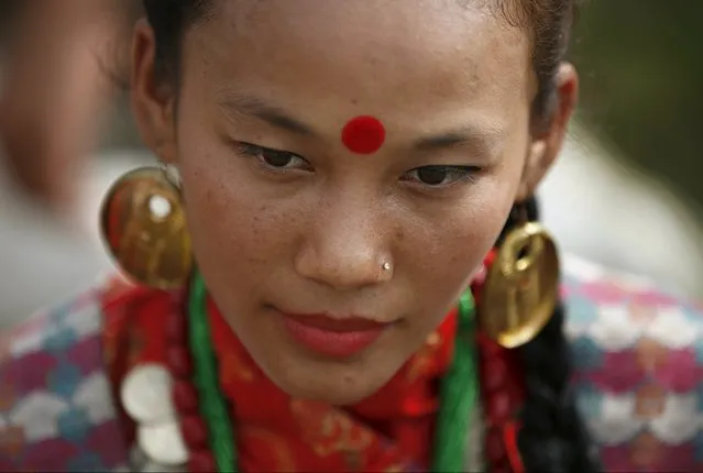 A woman dressed in traditional attire takes part in a celebration a day after the first democratic constitution was announced in Kathmandu, Nepal September 21, 2015. (Photo by Navesh Chitrakar/Reuters)