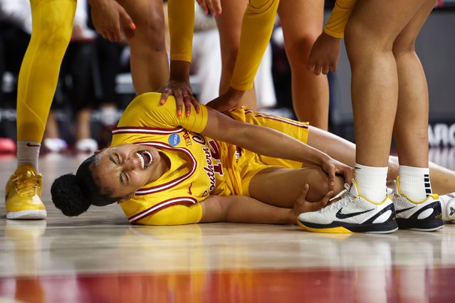 USC superstar basketball player JuJu Watkins holds her knee in agony after she injured it during an NCAA Tournament game on Monday, March 24, 2025. She will miss the rest of the tournament. (Photo by Jessie Alcheh/AP Photo)