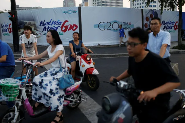 People cycle past a billboard for the upcoming G20 summit on street in Hangzhou, Zhejiang province, China September 1, 2016. (Photo by Aly Song/Reuters)