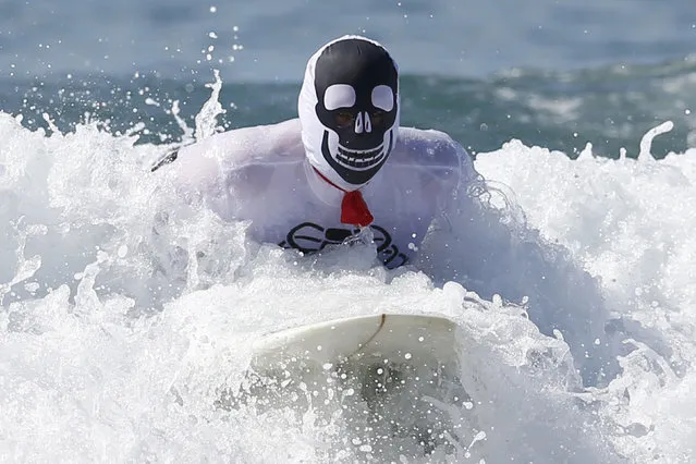 A competitor rides a wave during the 7th annual ZJ Boarding House Haunted Heats Halloween surf contest. (Photo by Lucy Nicholson/Reuters)