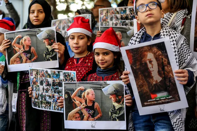 Lebanese and Palestinians from the Khiam Rehabilitation center for the victims of torture (KRC) carry pictures of Palestinian detainees during a protest calling for the freedom of 17-year-old Palestinian girl Ahed Al-Tamimi, in front the International Committee of the Red Cross (ICRC) in Beirut, Lebanon, 26 December 2017. The Israeli Army arrested child activist Ahed Al-Tamimi on 19 December 2017 after the outbreak of the Jerusalem uprising following the decision of US President Donald Trump's recognition of Jerusalem as capital of Israel. As of 18 December 2017, the number of Palestinian detainees since the start of the Intifada has reached 350, including 48 children between the ages of 12 and 17. (Photo by Nabil Mounzer/EPA/EFE)