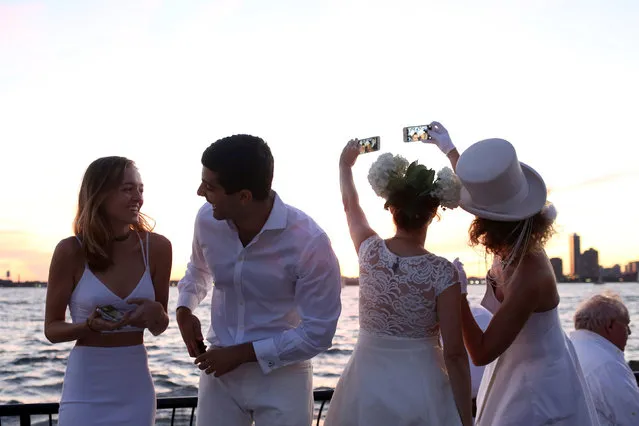 People attend Diner En Blanc, the French-inspired secret pop-up dinner, in Robert F. Wagner Jr. Park, in New York, U.S., September 15, 2016. Picture taken September 15, 2016. (Photo by Alex Wroblewski/Reuters)