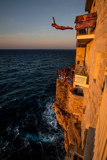 In this handout image provided by Red Bull, Nikita Fedotov of Armenia dives from the 26 metre balcony during the first competition day of the second stop of the Red Bull Cliff Diving World Series on June 28, 2025 at Polignano a Mare, Italy. (Photo by Dean Treml/Red Bull via Getty Images)