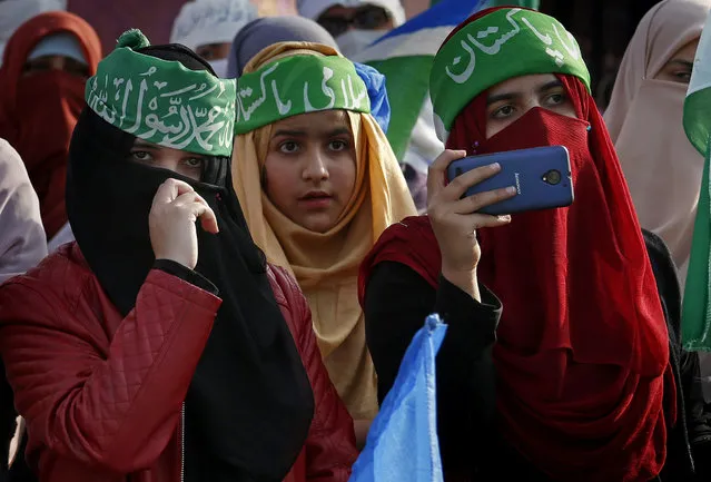 Supporters of the religious group, Jamaat-e-Islami, listen to their leaders during a rally to mark Kashmir Solidarity Day, in Islamabad, Pakistan, Monday, February 5, 2018. Pakistanis observe Kashmir Day annually on Feb. 5 to support Indian Kashmiris struggling for independence. (Photo by Anjum Naveed/AP Photo)