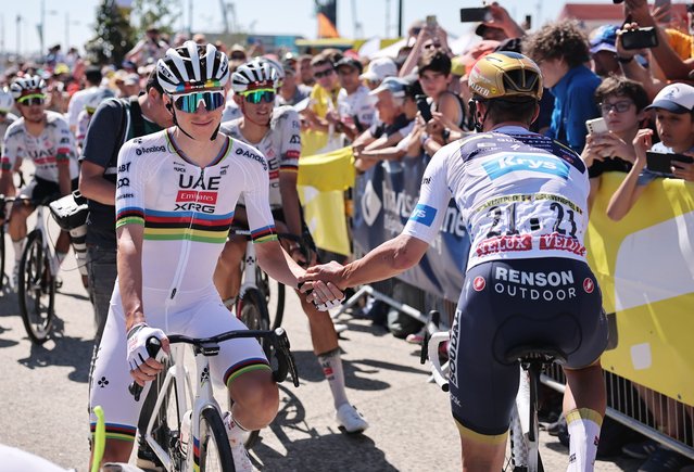 Slovenian rider Tadej Pogacar of UAE Team Emirates (L) and Belgian rider Remco Evenepoel of Soudal Quick-Step team shake hands prior the 7th stage of the Tour de France cycling race over 197km from Saint Malo to Mur-de-Bretagne, France, 11 July 2025. (Photo by Christophe Petit-Tesson/EPA)