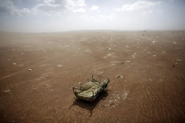 A cradle left behind by Syrian Kurdish refugees lies at the Turkish-Syrian border near Suruc, in this September 27, 2014 file photo. A crossing point along the Turkish-Syrian border frontier was normally a hive of activity, with wailing children and families desperately trying to carry whatever they could manage across the dusty terrain. To my surprise on this particular day, the refugee collection didn't start. (Photo and caption by Murad Sezer/Reuters)