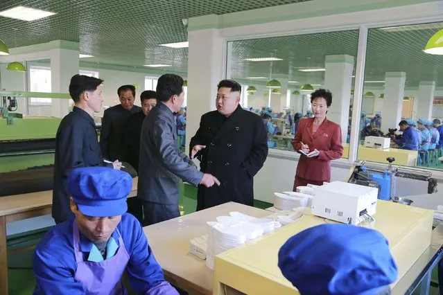 North Korean leader Kim Jong Un (C) gives field guidance during his visit to the Wonsan Shoes Factory in this undated photo released by North Korea's Korean Central News Agency (KCNA) in Pyongyang January 31, 2015. (Photo by Reuters/KCNA)