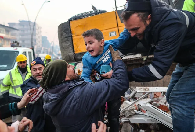Eight-year-old Yigit Cakmak (C) reacts after being rescued from the site of a collapsed building, some 52 hours after a major earthquake, in Hatay, Turkey, 08 February 2023. More than 7,000 people have died and thousands more injured after two major earthquakes struck southern Turkey and northern Syria on 06 February. Authorities fear the death toll will keep climbing as rescuers look for survivors across the region. (Photo by Erdem Sahin/EPA/EFE/Rex Features/Shutterstock)