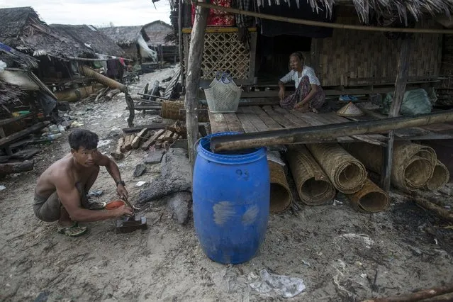 A family passes the time at their home in Kyaukpyu township, Rakhine state, Myanmar October 6, 2015. (Photo by Soe Zeya Tun/Reuters)