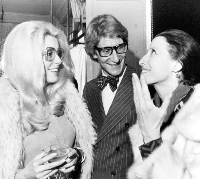 French fashion designer Yves Saint-Laurent is congratulated by French actress Catherine Deneuve, left, and Russian ballerina Maia Plissetskaia, after the presentation of his collection in Paris, January 25, 1973. (Photo by Jean Jacques Levy/AP Photo)