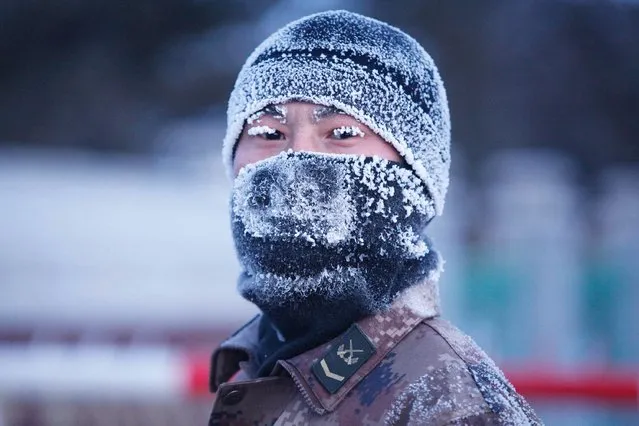A soldier looks on during a practise drill in temperatures of about minus 30 degrees centigrade (-22 F) in Heihe, Heilongjiang province, December 16, 2014. (Photo by Reuters/China Daily)
